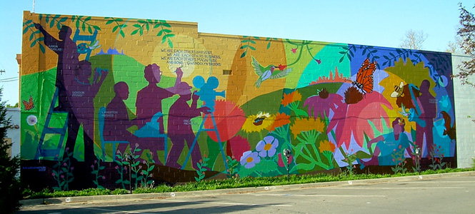 Mural painted on the side of a building featuring artists who have contributed to society as activists.