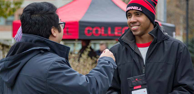 Two students greeting each other on campus.