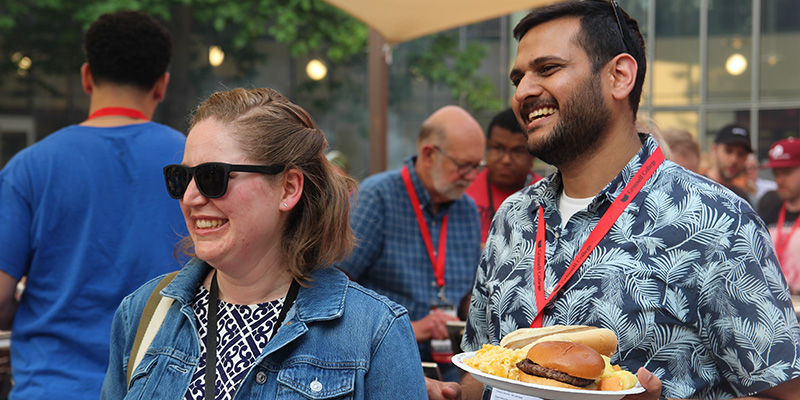 Shitanshu Aggarwal ’11, right, and another All Reunion dinner attendee get their food.