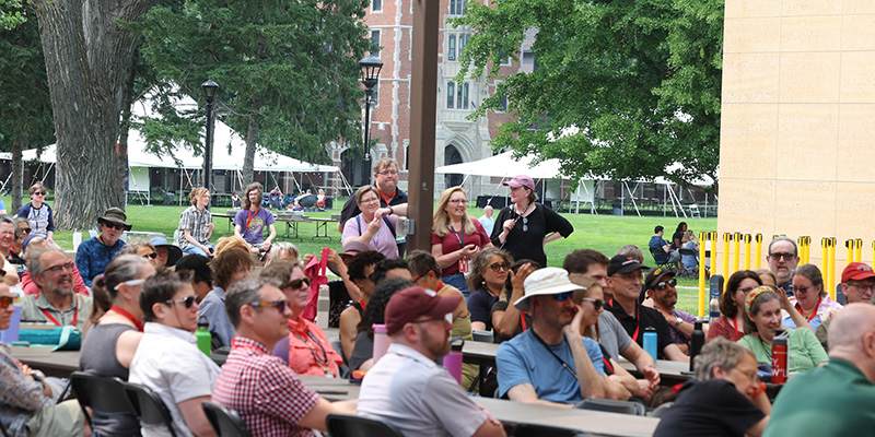 Grinnellians gather in the JRC Courtyard for Moth storytelling.