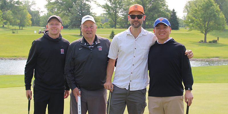 Connor McKay, left, Grinnell interim golf coach; Greg Wallace, retired football and golf coach, and athletic director; are joined by Kennon Landis ’09 and Carlos Lu ’10.