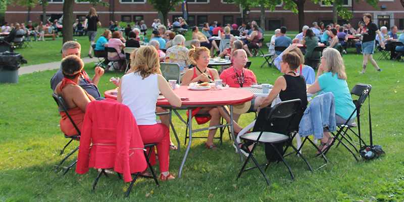 Grinnellians enjoy the outdoor setting and togetherness at the All-Reunion Dinner Saturday evening.