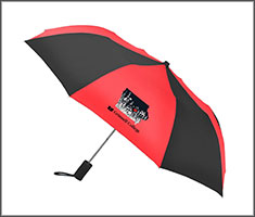A red and black umbrella with a Reunion 2026 logo.