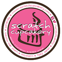 Logo for Scratch Cupcakery. A black stylized cupcake sits on a pink circle. White text in front: Scratch Cupcakery. 