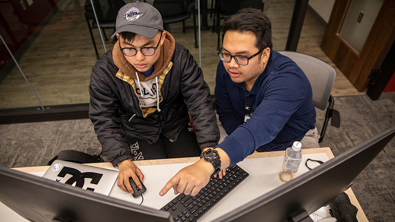 Two students partner to work through information in the Data Analysis and Social Inquiry Lab at Grinnell College.
