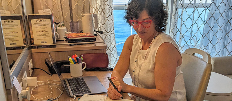 Goldmacher writes a desk from her cruise room.