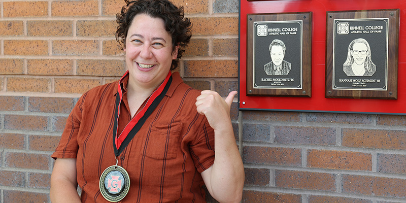 Rachel Moskowitz ’06 stands next to her plaque at the Athletic Hall of Fame.