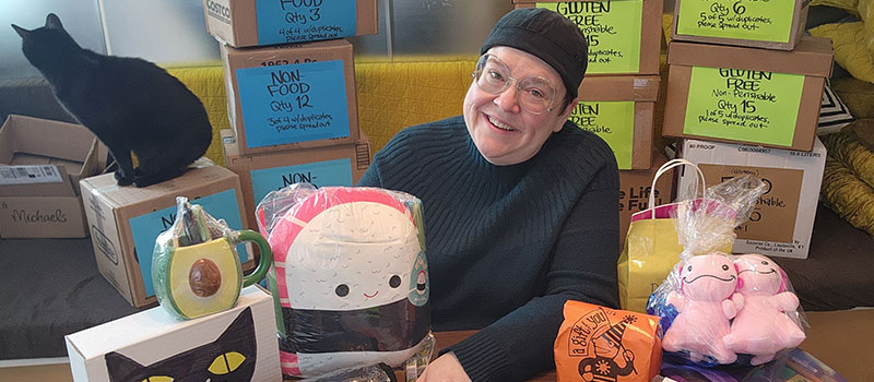 Brandy Agerbeck ’96 pictured with snacks, plushes, and other goodies she includes in care packages. 