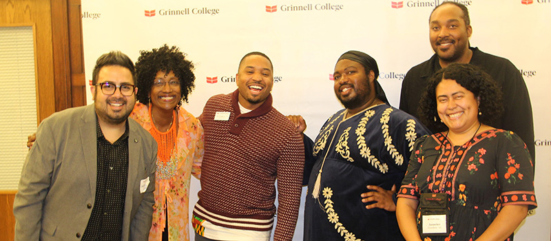 Lester Alemán ’07, left, and Jasmine E. Sánchez ’10, right, are pictured with senior faculty member Kesho Scott and other alums