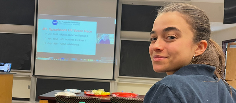 Sophia Ramalli ’27 looks back at the camera while watching a presentation. 