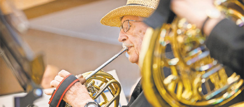 Dave Scott '50 plays french horn during a Golden Notes concert.