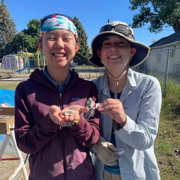 Avajane Lei ’28 and Julia Ghorai ’27 show fragments of a porcelain rice bowl they found.
