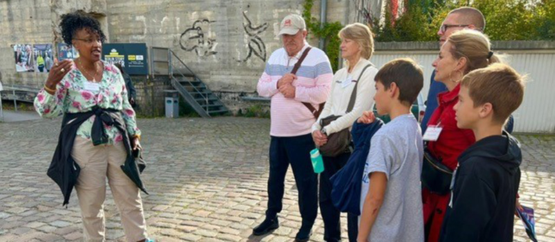 Kesho Scott, left, discusses a World War II bunker in Berlin with the Freeman and Sandquist families.