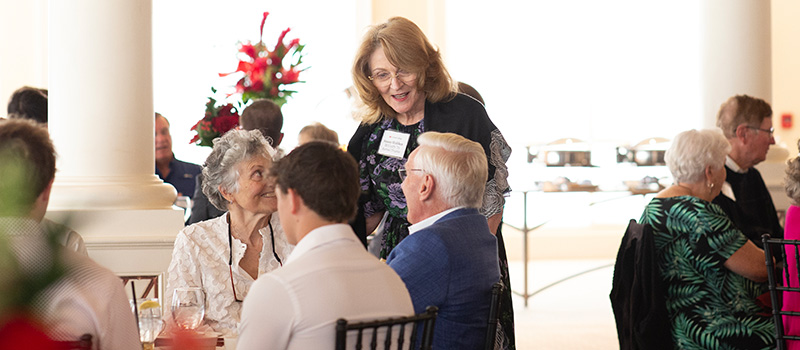 Susan Holden McCurry ’71 talks with fellow Grinnellians during a reception and luncheon she co-hosted in Naples, Florida, on Jan. 5.