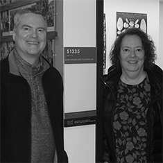 Kevin Rhodes ’85 and Melinda (Lindy) Lopes ’85 stand in front of the Lopes Rhodes Dirty Teaching Lab in the HSSC.