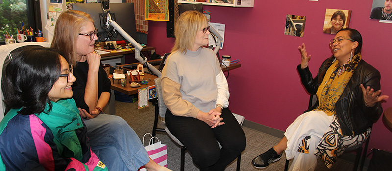 Inga Jacobs-Mata &rsquo;04 chats with Diya Shrestha &rsquo;26, left, Karen Edwards, and Brenda Strong.