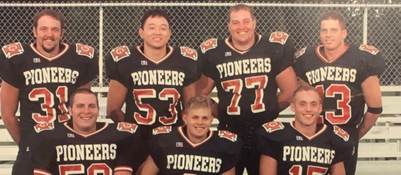 Jim Schueller ’03, uniform number 13, is pictured with his Grinnell College football teammates.