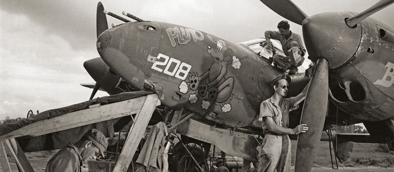 a World War II aircraft displays an image of the Disney cartoon character Pluto. 