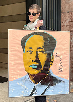 Nikki Carlson’s daughter, Adriana, holds up original artwork created by Andy Warhol