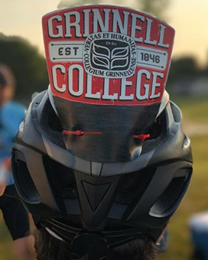 Grinnell College emblem attached to a bike helmet