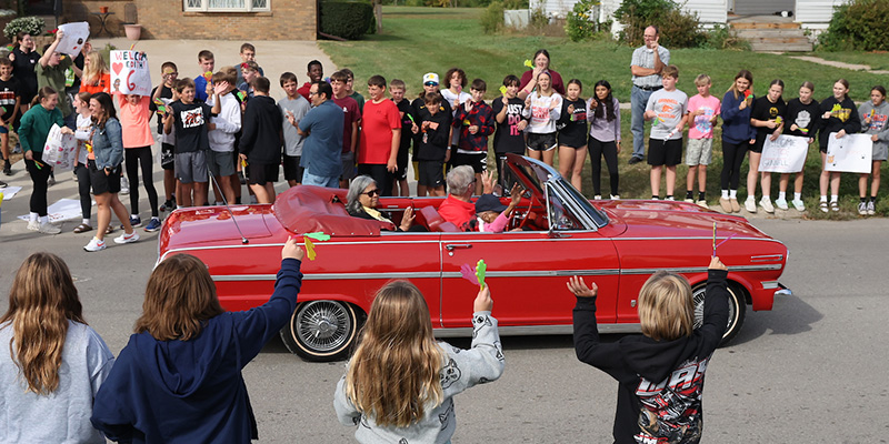 Renfrow Smith waves to Grinnell residents who lined the parade route Friday morning.