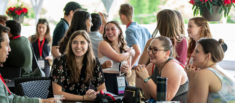 A group of alumni chat during the 2024 Pioneer Athletics Reception.