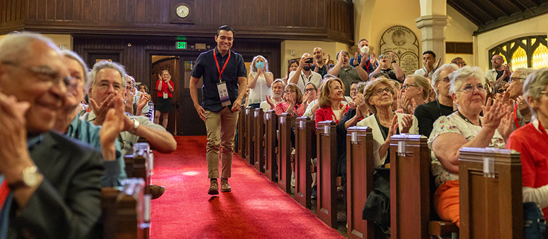 Alumni Assembly attendees during Reunion 2025 cheer on an award recipient.