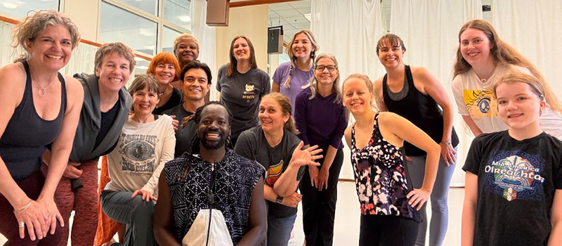 Aguibou Sanou, assistant professor of theatre, dance, and performance studies, pose with attendees of a dance workshop at Reunion.