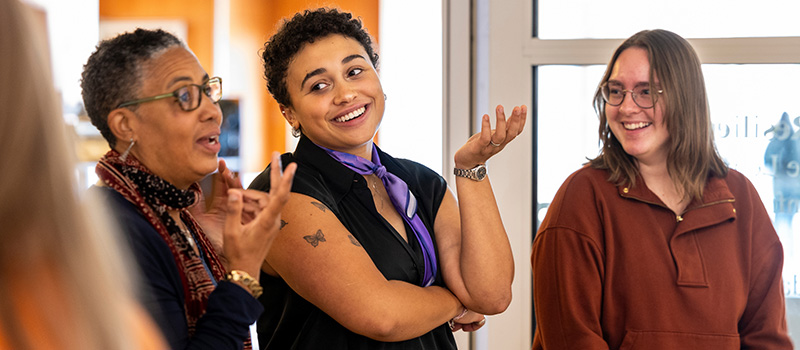 Dr. Tamara Beauboeuf-Lafontant, left, and Valeriya Woodard ’25 talk during the Rooted in Resilience exhibit event.