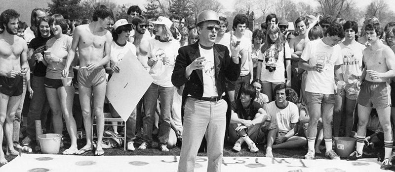 A 1983 photo shows Wayne Moyer giving instructions before students play a game of Twister at the Grinnell Relays.