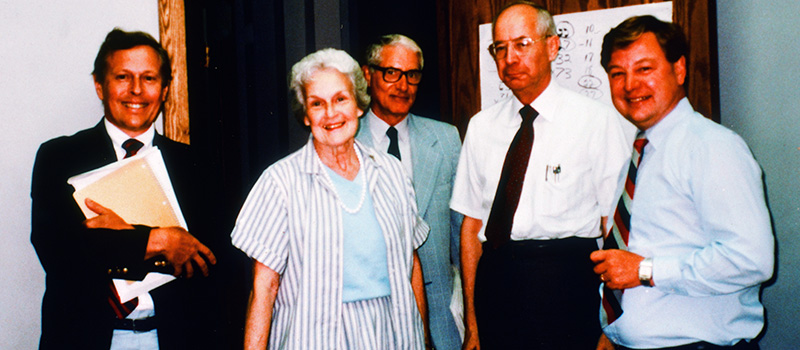 Moyer, left, poses for a photo with meeting attendees at the Iowa Peace Institute in 1988.