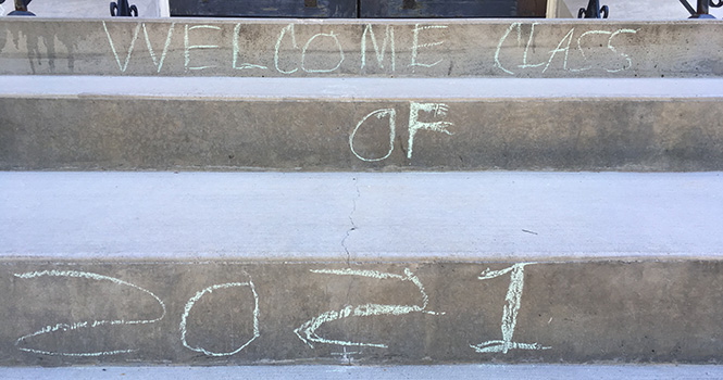 Welcome Class of 2021 written in chalk on the steps going into Herrick Chappel