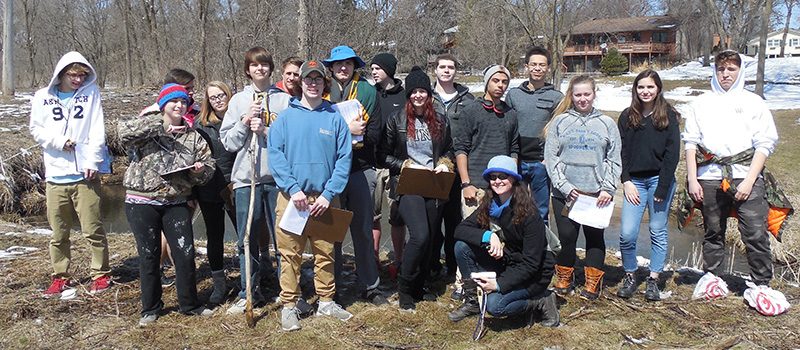 A group of students assists Tovah Flygare ’88 with a project for the St. Croix Master Watershed program.