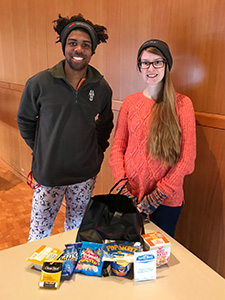 Two students picking up their Care Package.