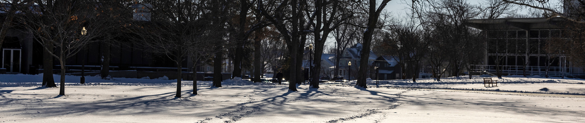 Snow covers the field in front of Burling Library and the Forum on the campus of Grinnell College. 