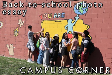 Text: Campus Corner - Back to school photo essay. Image: Students posing in front of a mural depicting a cartoon state of Iowa outline with the words, "You are here"