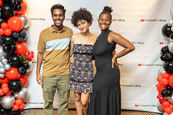 A trio of students pose for a photo at the Dinner Event during Black Alumni Weekend. 