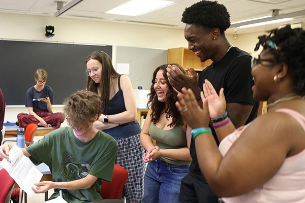 Student laugh while working through a group exercise. 