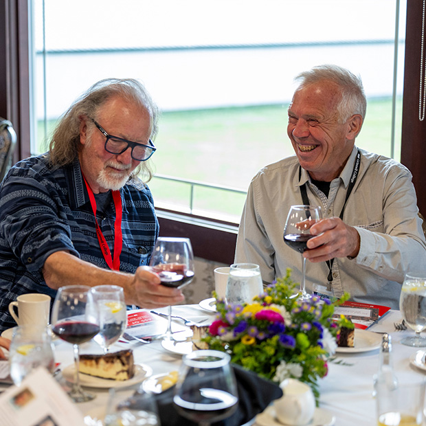 Two members of the class of 1975 enjoy a laugh during their Class Dinner at Reunion 2025.