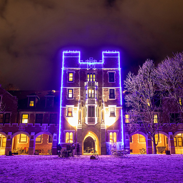 Gates Tower on the campus of Grinnell College lit up with Blue Lights for Arctic Lights 2024.