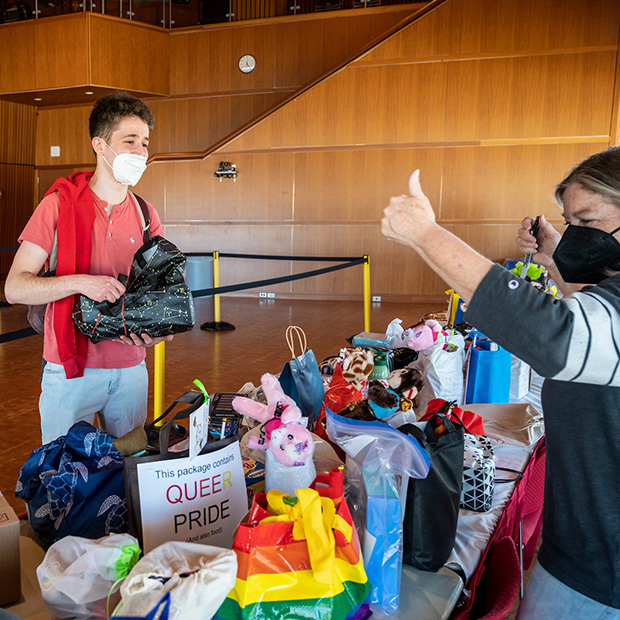 Laura Shepherd ’82 gives a thumbs-up to a student selecting a care package Wednesday at the Joe Rosenfield ’25 Center on the Grinnell College campus.