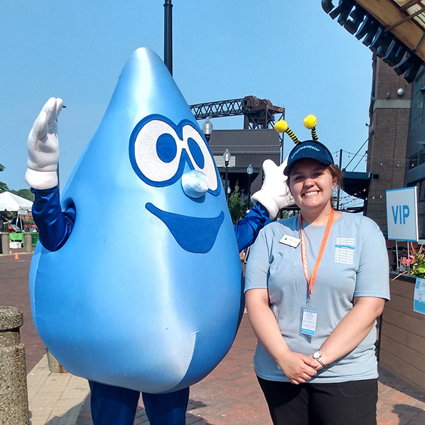 Isabelle Kolleth ’24 poses with a water droplet mascot.
