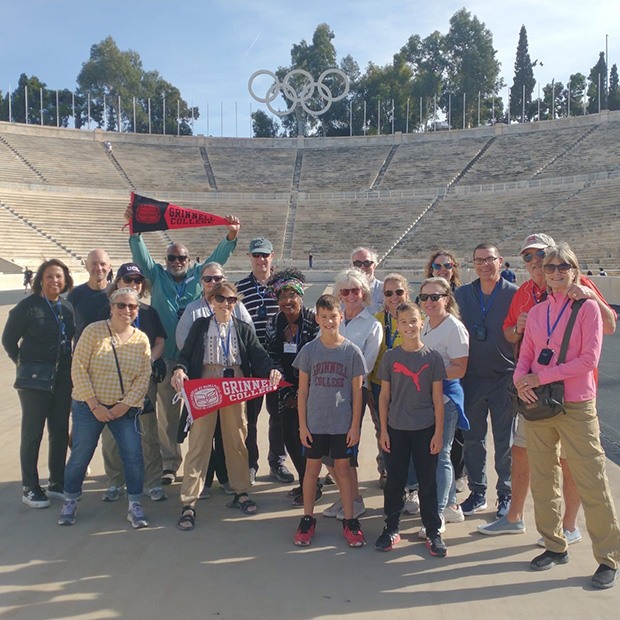 A group photo of the Fall 2024 Grinnellian Adventures group taken at the Olympic stadium in Athens, Greece. 