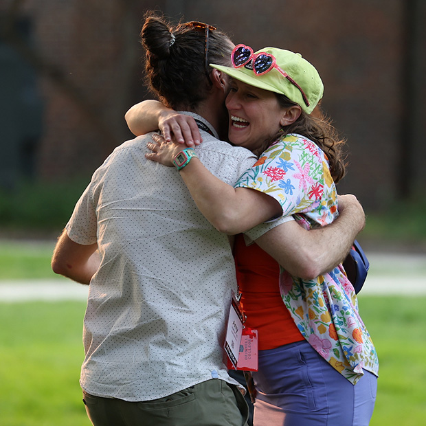 Amy Hadow '10, left, shares a hug with a fellow Reunion attendee.