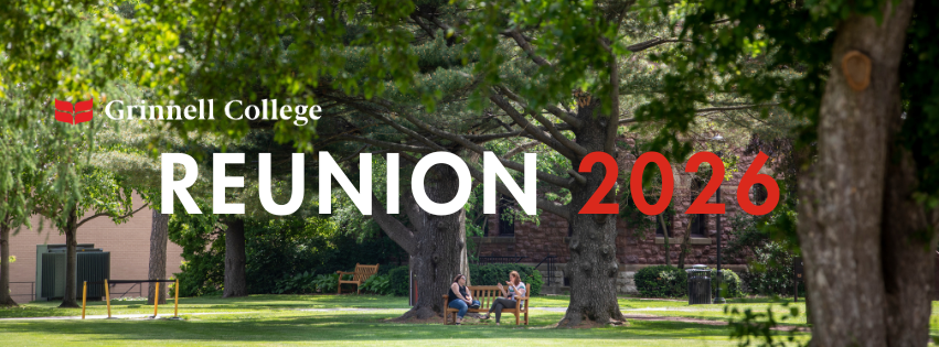 2 alums sitting on a bench under the trees on campus