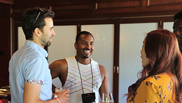 Ben Vaughn and Jenny Dong chat with other alumni during Young Alumni Weekend.