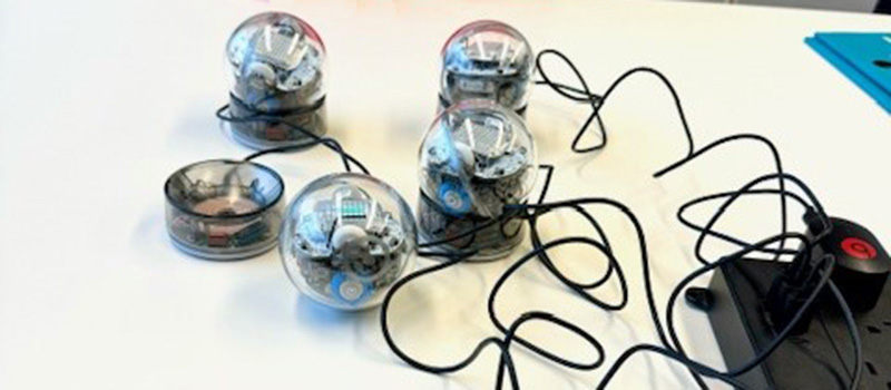 Small, circular orb robots that can light up and change direction.
